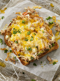 tuna and cheese melt open face sandwich on plate_1074288958
