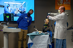 some Cambridge Medical Center providers perform a procedure using a robot.