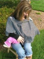 a blanket covers baby while breastfeeding in public