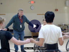 volunteer wheelchair basketball coach Doug Dixon on the court with some of his team
