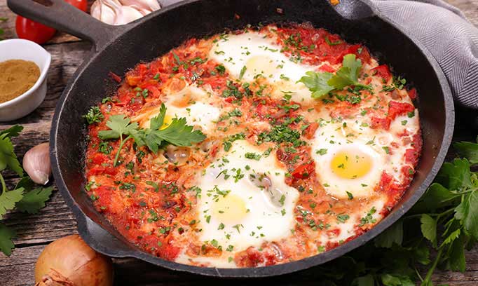 Shakshouka, a Middle Eastern tomato and egg stew shown in a cast iron skillet