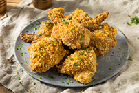 spicy oven fried chicken on a light blue plate 1189424581