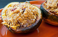 a healthy vegetarian recipe photo shows two halves of stuffed acorn squash with brown rice 183767023
