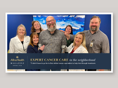 Patient surrounded by care team.