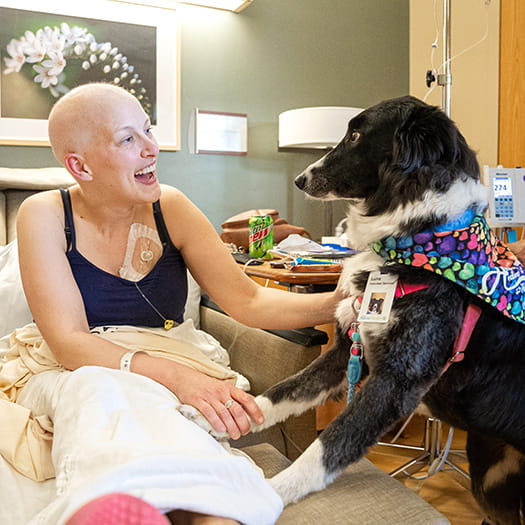 Cancer patient in hospital with support dog