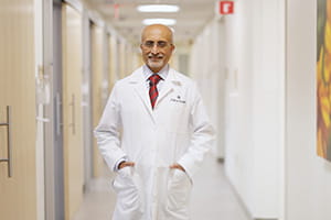 Dr. Badrinath Konety in a white coat in a hospital 