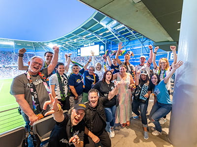 Alina Health employees cheering at Allianz Field.