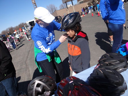 child getting fitted for bike helmet