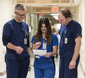 a picture of three nurses conferring at Abbott Northwestern Hospital