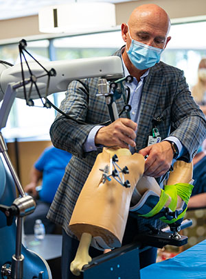 a surgeon demonstrating the Mako surgical Robot 