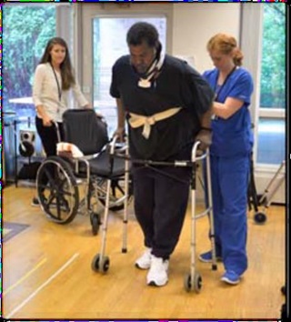 Volunteering in physical and occupational therapy helping patient walk