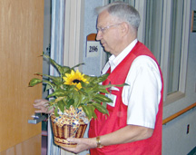 regina hospital volunteer delivering flower