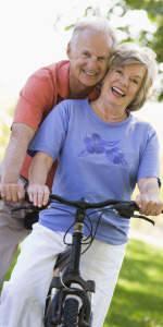 A middle-aged couple smiles as they bike through Fridley, Minnesota.