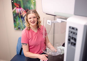 Staff member sitting at a work station in the Mammo on the Move truck