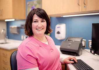 Staff member at a computer station on the Mammo on the Move truck