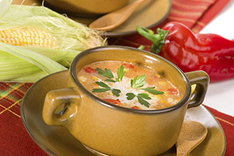 corn and red pepper soup in a bowl