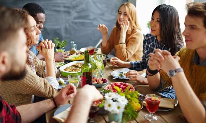 friends at dinner and how to handle holiday stress as an introvert