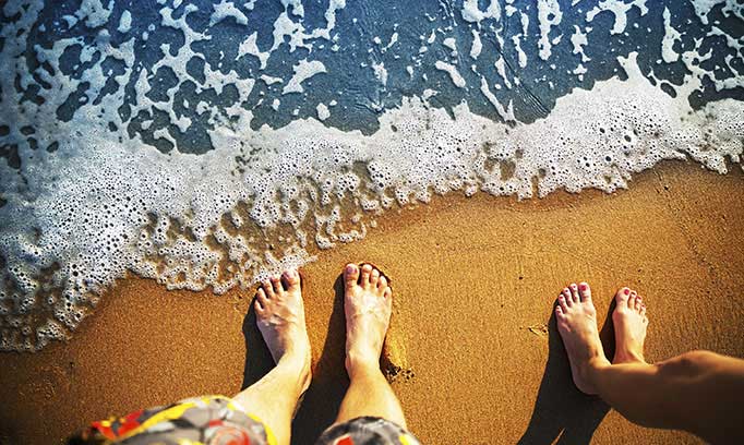 feet on beach, how to avoid vacation stress