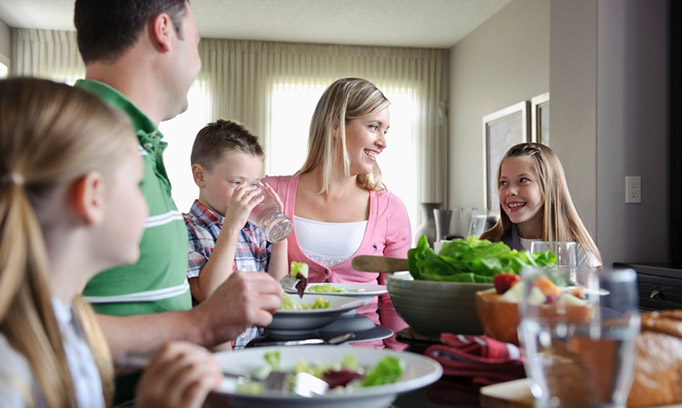 family at dinner table trying to start healthy habits