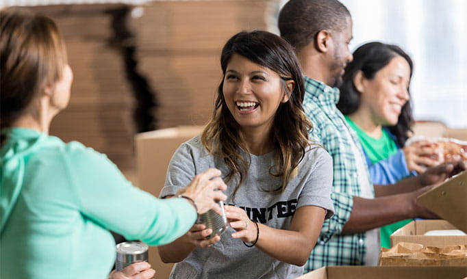 Group of volunteers pack boxes for a charitable organization