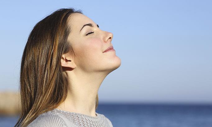 Woman feeling the benefits of deep breathing