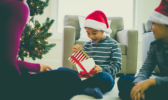 boy opening gift 682x408 gettyimages 869856306