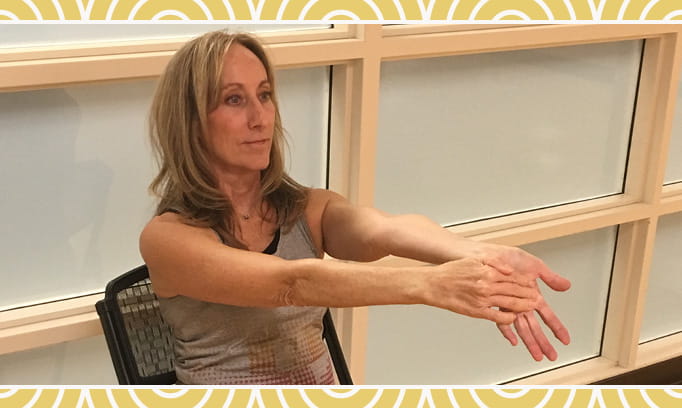 woman doing upper body chair yoga pose