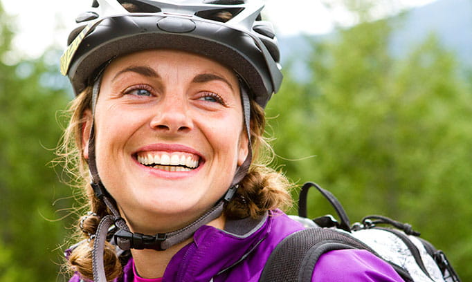 young woman wearing bike helmet exercising her body and her brain