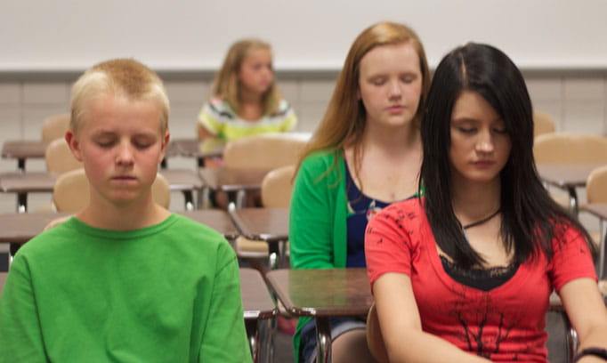 Kids in a classroom practice guided imagery as a way to reduce stress