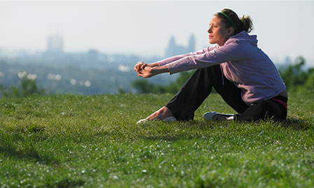 Woman contemplative resting in grass listicle size
