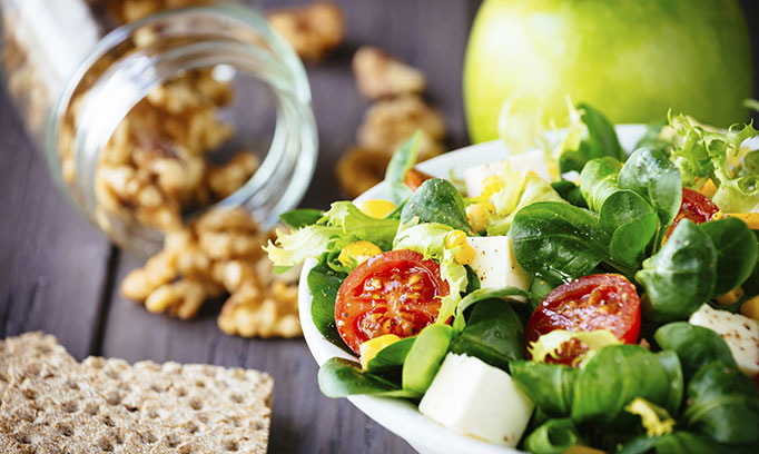 Leafy green salad with tomatoes and nuts are among the foods that help reduce the risk of colon cancer. 