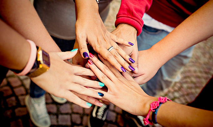 Women displaying manicured nails with nail polish