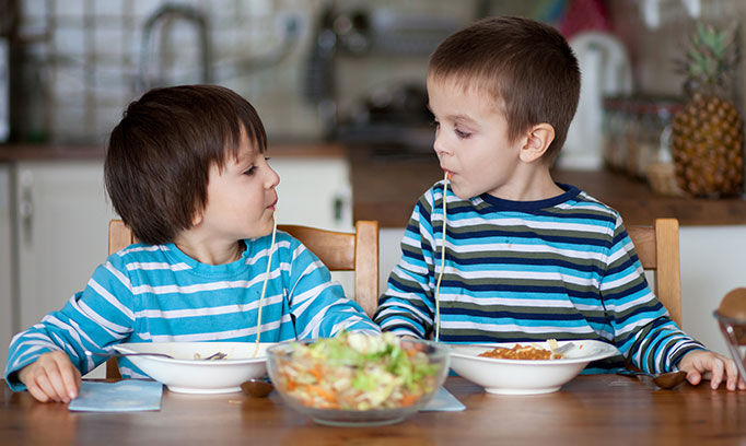Kids enjoying family meal time and the benefits of eating together