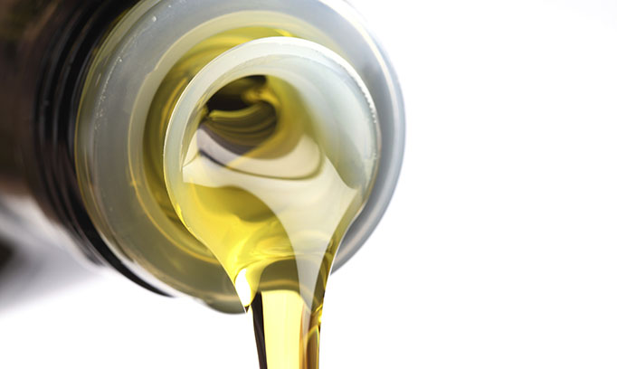 Shown being poured from a bottle, olive oil has many health benefits