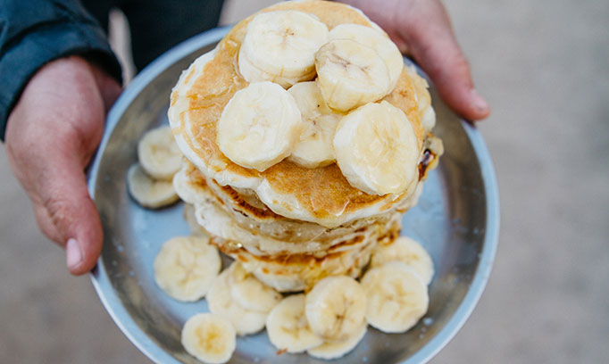 Bird's eye view of a stack of banana pancakes on a plate