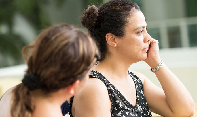 Woman listens carefully to help a friend struggling with suicidal thoughts