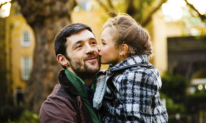 Dad and young daughter share a tender moment of gratitude