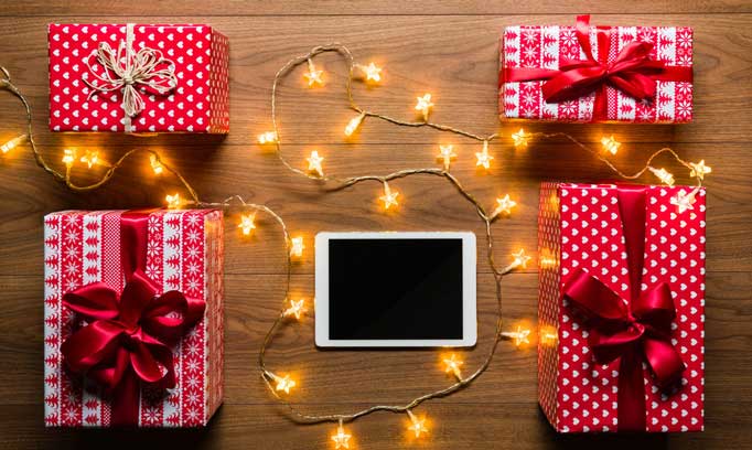 Wrapped presents surrounded by holiday lights