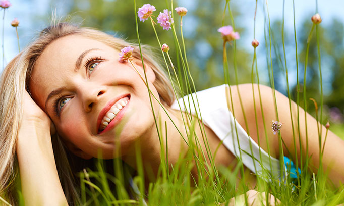 Woman takes time to notice the beauty of wildflowers and grasses 