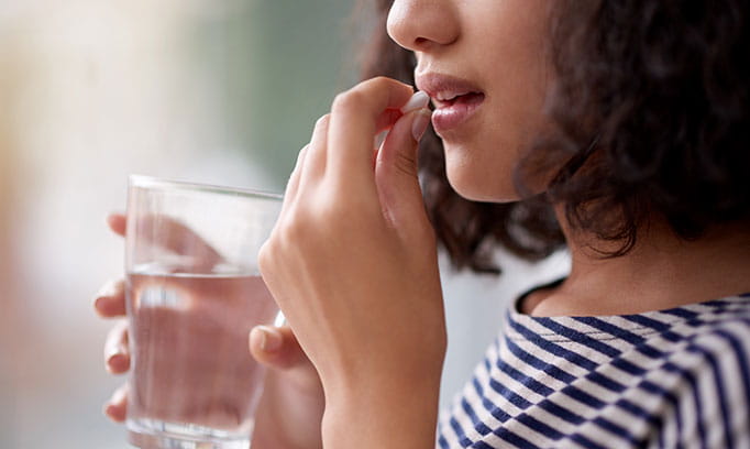 Woman taking pill 