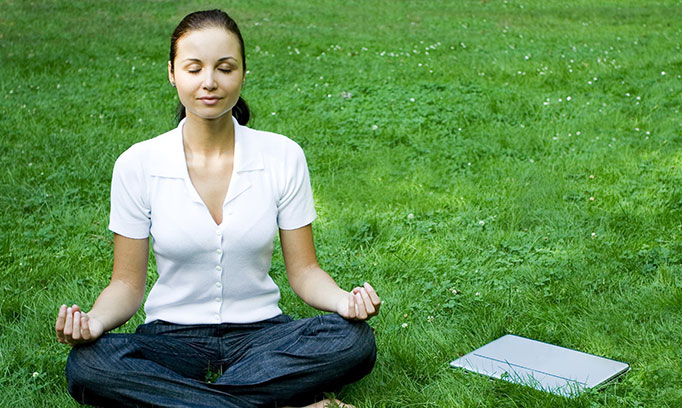 woman seated outside practicing meditation for healthy lifestyle