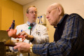 older man speaks with doctor about how well his pacemaker is working