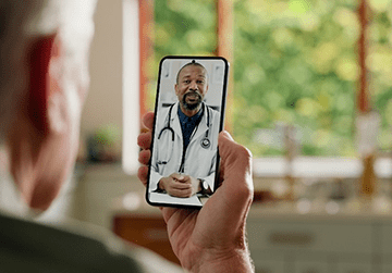 Patient on a video call on his phone with an orthopedic doctor.