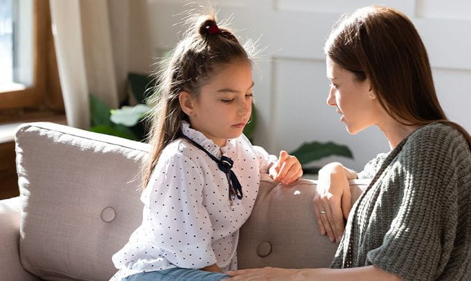 Pictured is a mother talking to her daughter about cancer