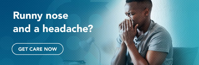 Runny nose and a headache? Get care now. Pictured is a man blowing his nose.