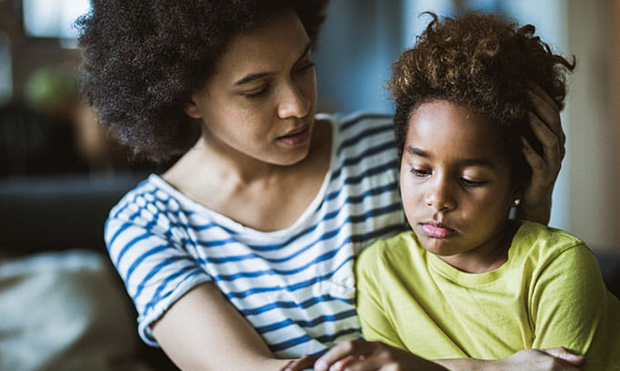 Mother comforting their child who is sad from toxic positivity