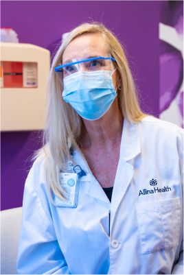 doctor in mask who works at allina health cancer center