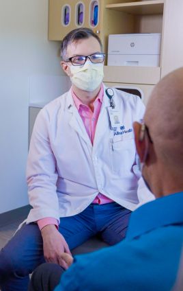 doctor listening to patient for prostate cancer symptoms