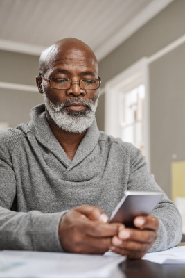 male looking at his phone for colon cancer risk factors