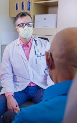 provider taking health history during cancer exam